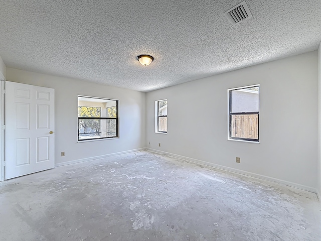 5701 Autumn Ridge Rd, Lake Worth, FL 33463 - empty room featuring unfinished concrete flooring, a textured ceiling, and baseboards