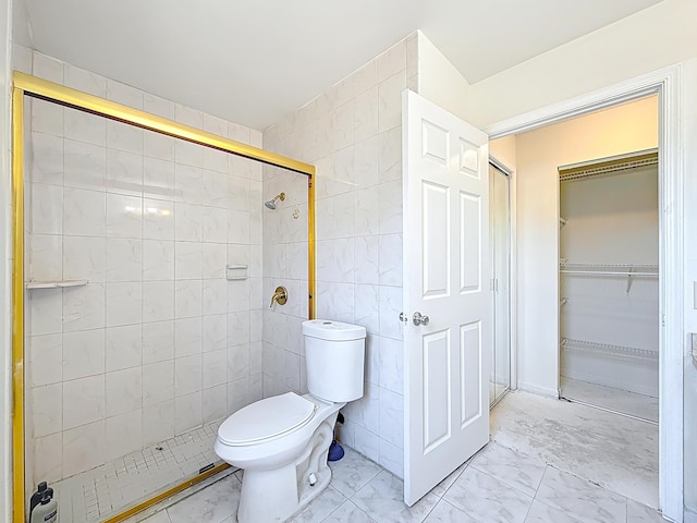 5701 Autumn Ridge Rd, Lake Worth, FL 33463 - bathroom with marble finish flooring, tiled shower, tile walls, toilet, and a walk in closet