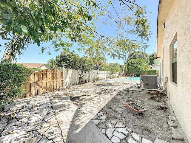 5701 Autumn Ridge Rd, Lake Worth, FL 33463 - view of patio with central AC unit and a fenced backyard