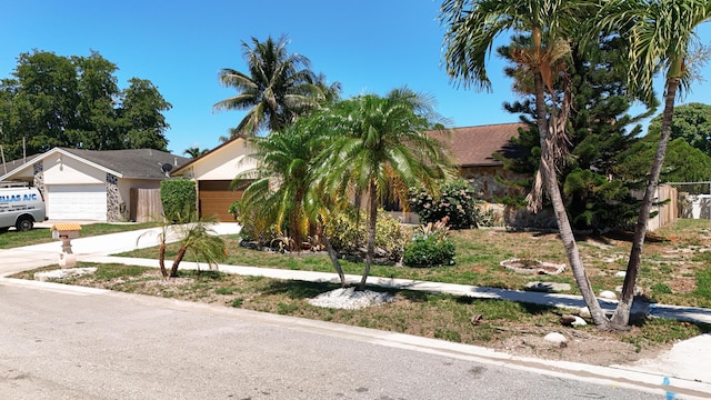 5701 Autumn Ridge Rd, Lake Worth, FL 33463 - view of property hidden behind natural elements featuring an attached garage and driveway