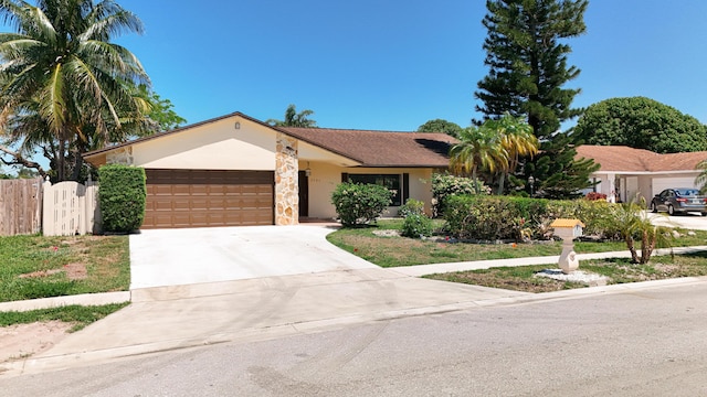 5701 Autumn Ridge Rd, Lake Worth, FL 33463 - ranch-style house with an attached garage, driveway, fence, and stucco siding