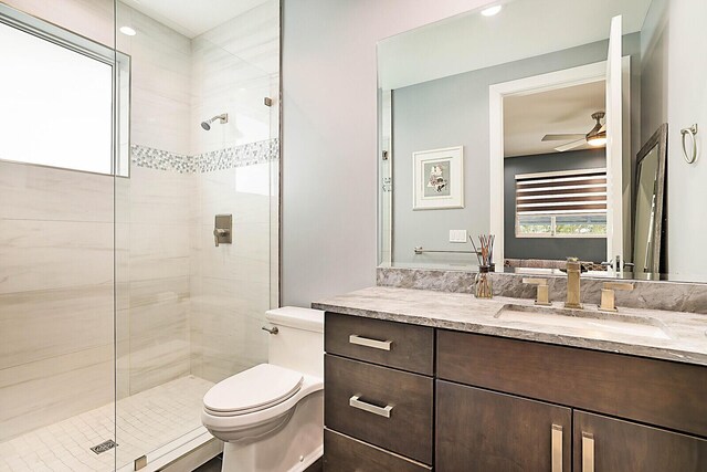 311 SE 11th St, Pompano Beach, FL 33060 - bathroom with a stall shower, toilet, a ceiling fan, and vanity