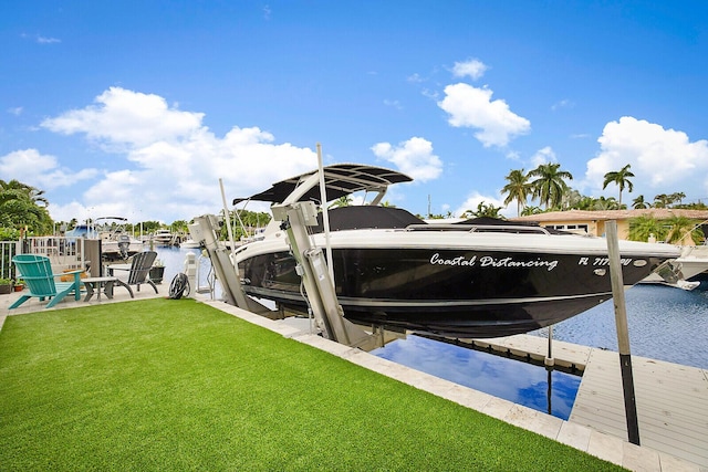 311 SE 11th St, Pompano Beach, FL 33060 - dock area with boat lift, a lawn, and a water view