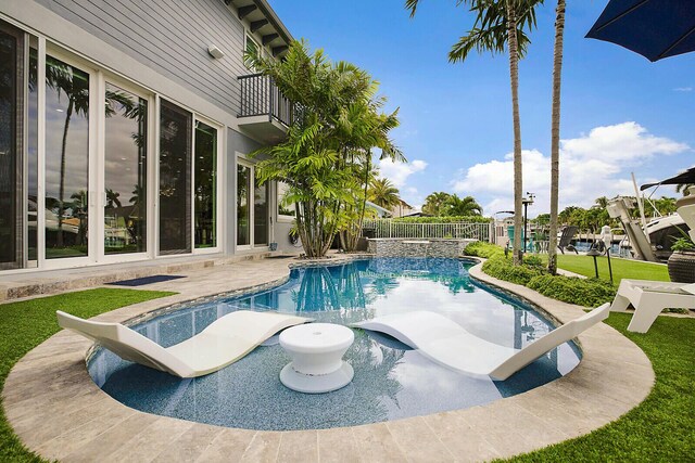 311 SE 11th St, Pompano Beach, FL 33060 - view of swimming pool featuring a water slide, a fenced backyard, a patio area, and a pool with connected hot tub