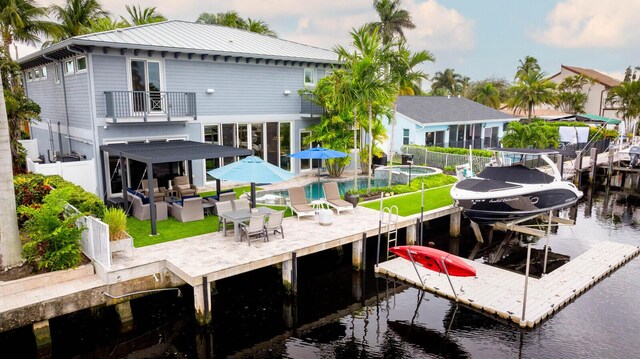 311 SE 11th St, Pompano Beach, FL 33060 - dock area with a water view, boat lift, an outdoor pool, and a balcony