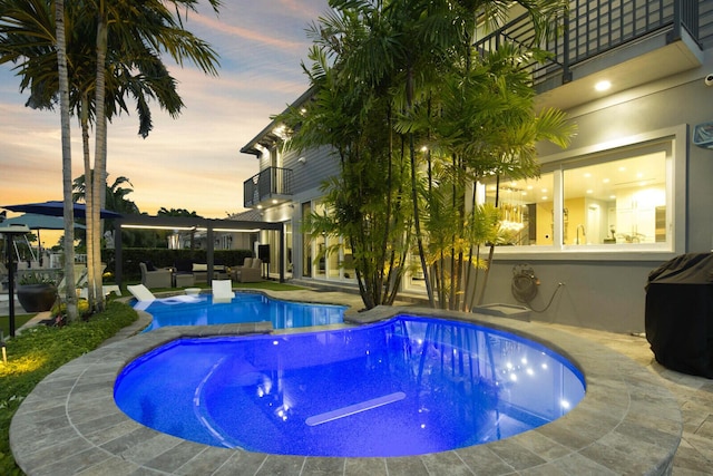 311 SE 11th St, Pompano Beach, FL 33060 - pool at dusk with an outdoor pool and a patio area