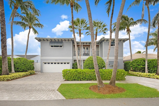 311 SE 11th St, Pompano Beach, FL 33060 - view of front of property featuring decorative driveway, a balcony, and an attached garage