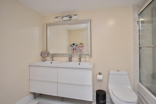 2301 Lucaya Ln Unit M3, Coconut Creek, FL 33066 - full bathroom featuring double vanity, toilet, shower / bath combination with glass door, tile patterned flooring, and baseboards