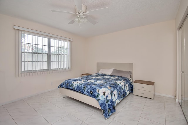 2301 Lucaya Ln Unit M3, Coconut Creek, FL 33066 - bedroom with light tile patterned flooring, baseboards, a ceiling fan, and a textured ceiling