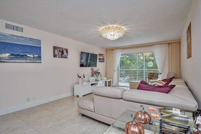 2301 Lucaya Ln Unit M3, Coconut Creek, FL 33066 - living room featuring a chandelier, a textured ceiling, baseboards, and light tile patterned floors