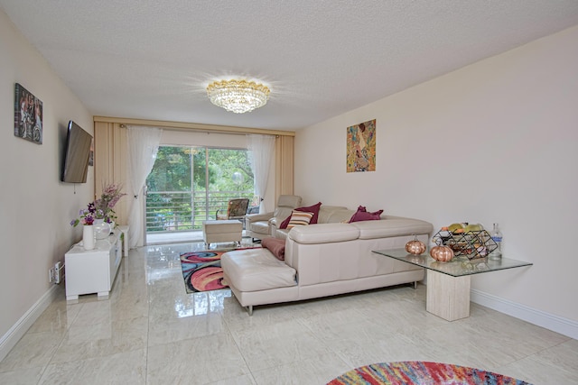 2301 Lucaya Ln Unit M3, Coconut Creek, FL 33066 - living room with baseboards, a textured ceiling, a chandelier, and light marble finish floors
