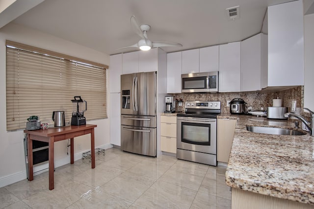 2301 Lucaya Ln Unit M3, Coconut Creek, FL 33066 - kitchen with stainless steel appliances, a sink, decorative backsplash, ceiling fan, and light stone counters
