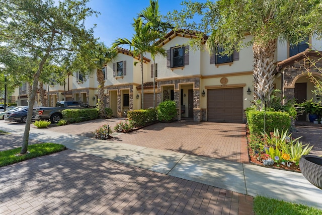 4080 Devenshire Ct, Coconut Creek, FL 33073 - view of front of home featuring stone siding, decorative driveway, stucco siding, and a garage