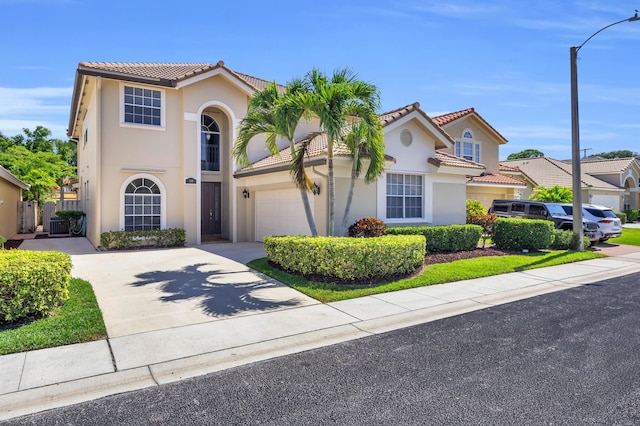 148 Cypress Cv, Jupiter, FL 33458 - mediterranean / spanish house with a tile roof, stucco siding, driveway, and a garage