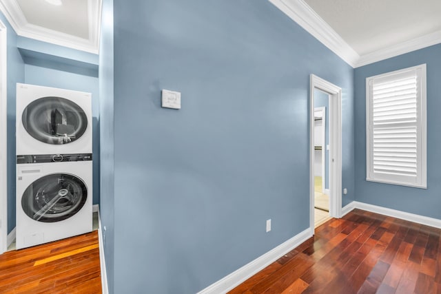 148 Cypress Cv, Jupiter, FL 33458 - washroom with estacked washer and dryer, crown molding, dark wood-style flooring, and baseboards