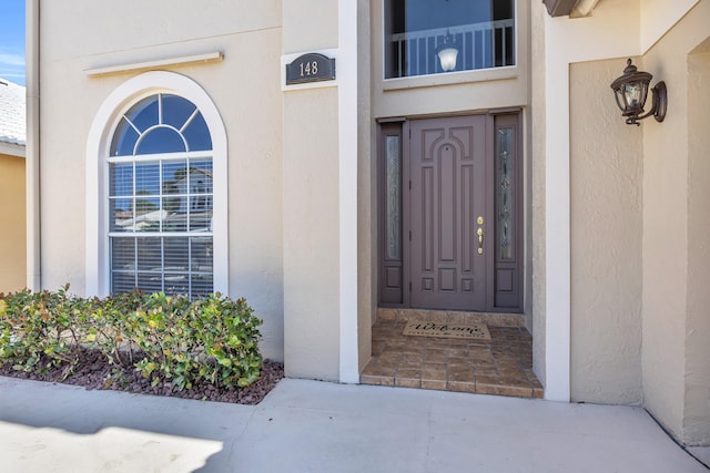 148 Cypress Cv, Jupiter, FL 33458 - doorway to property featuring stucco siding