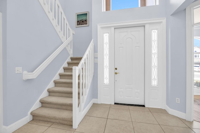 148 Cypress Cv, Jupiter, FL 33458 - tiled foyer entrance with stairs, baseboards, and a towering ceiling