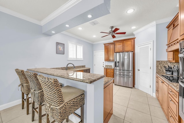 148 Cypress Cv, Jupiter, FL 33458 - kitchen with stainless steel refrigerator with ice dispenser, ornamental molding, a breakfast bar area, tasteful backsplash, and recessed lighting