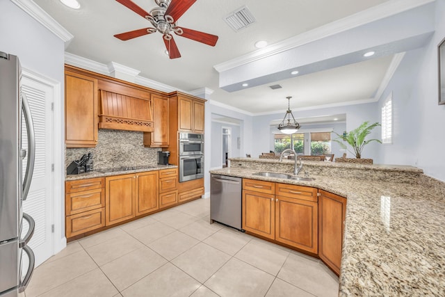 148 Cypress Cv, Jupiter, FL 33458 - kitchen featuring appliances with stainless steel finishes, a sink, ornamental molding, a ceiling fan, and brown cabinets