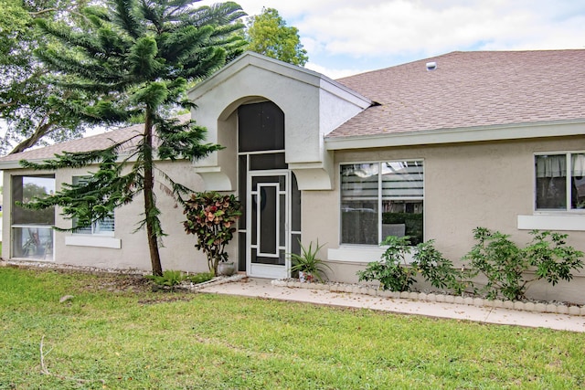 9112 Vineland Ct Unit A, Boca Raton, FL 33496 - view of front facade featuring a shingled roof, a front yard, and stucco siding