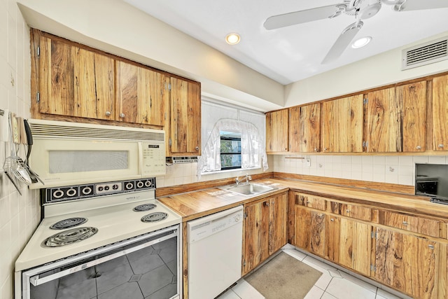128 Capri C, Delray Beach, FL 33484 - kitchen with white appliances, a sink, wood counters, backsplash, and recessed lighting