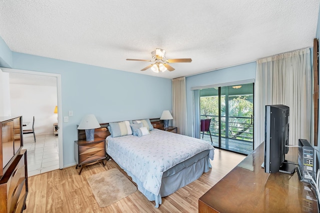 128 Capri C, Delray Beach, FL 33484 - bedroom featuring access to outside, a textured ceiling, light wood-style floors, and ceiling fan