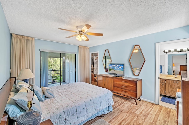 128 Capri C, Delray Beach, FL 33484 - bedroom with light wood-type flooring, a textured ceiling, a ceiling fan, a walk in closet, and access to outside