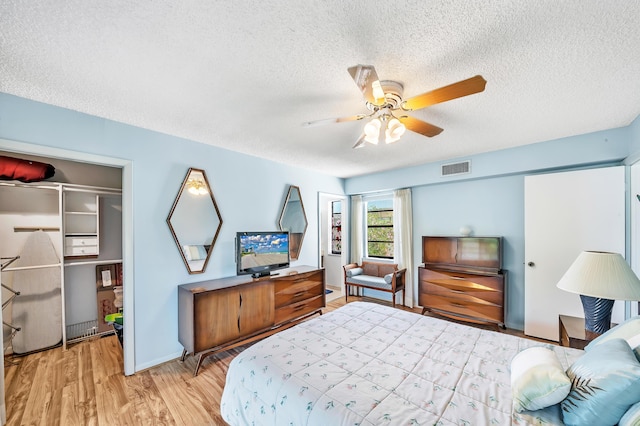 128 Capri C, Delray Beach, FL 33484 - bedroom featuring a textured ceiling, light wood finished floors, ceiling fan, and baseboards