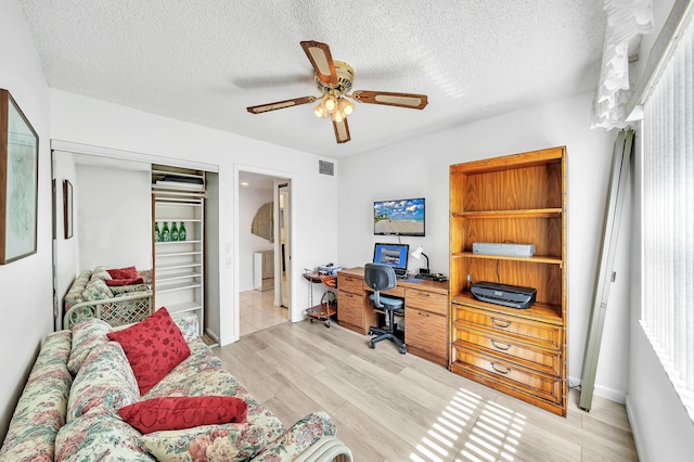 128 Capri C, Delray Beach, FL 33484 - office area featuring ceiling fan, light wood-type flooring, a textured ceiling, and baseboards