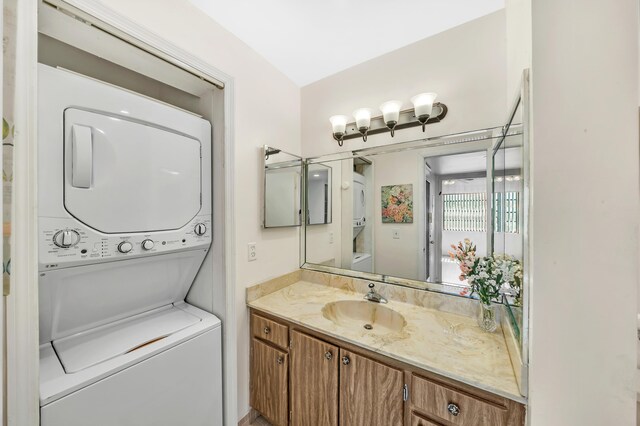 128 Capri C, Delray Beach, FL 33484 - bathroom with stacked washer / drying machine and vanity