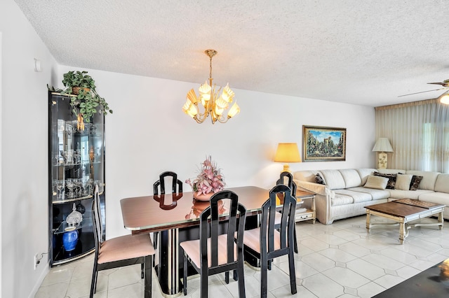 128 Capri C, Delray Beach, FL 33484 - dining area with a chandelier, a textured ceiling, and a ceiling fan