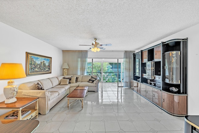 128 Capri C, Delray Beach, FL 33484 - living area featuring a ceiling fan and a textured ceiling