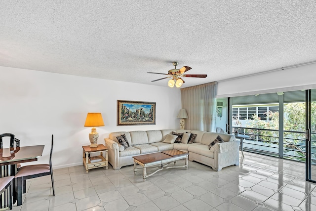 128 Capri C, Delray Beach, FL 33484 - living room featuring a ceiling fan, a textured ceiling, and light flooring