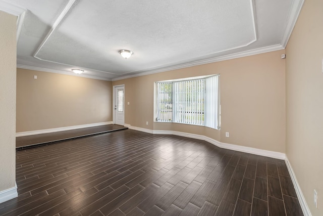 318 Gale Pl, West Palm Beach, FL 33409 - empty room featuring dark wood-type flooring, baseboards, ornamental molding, and a textured ceiling