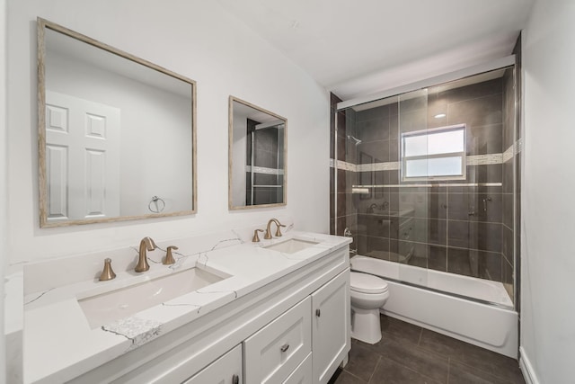 318 Gale Pl, West Palm Beach, FL 33409 - full bathroom with double vanity, toilet, combined bath / shower with glass door, and tile patterned floors