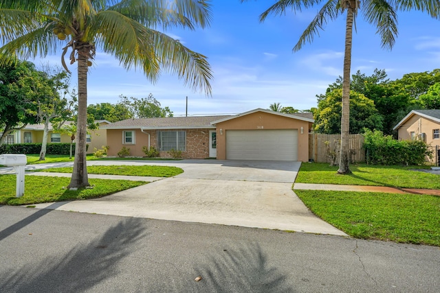 318 Gale Pl, West Palm Beach, FL 33409 - ranch-style home with an attached garage, stucco siding, and driveway