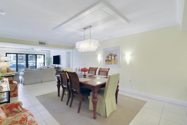 dining room featuring light tile patterned floors and a chandelier