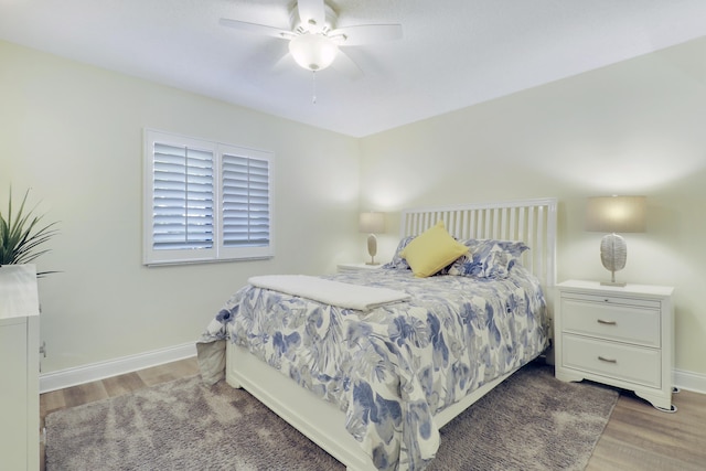 bedroom with wood finished floors, baseboards, and ceiling fan