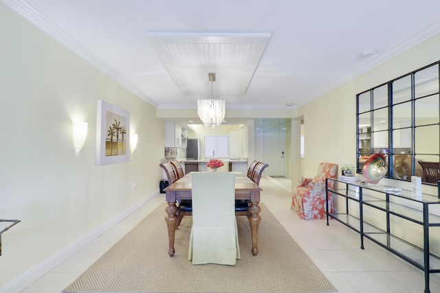 dining space with a chandelier, ornamental molding, light tile patterned floors, and baseboards