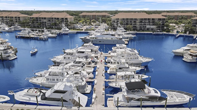 drone / aerial view of a nearby body of water and numerous boat docks