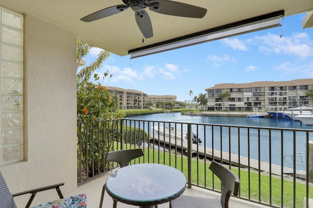 balcony with a water view and ceiling fan