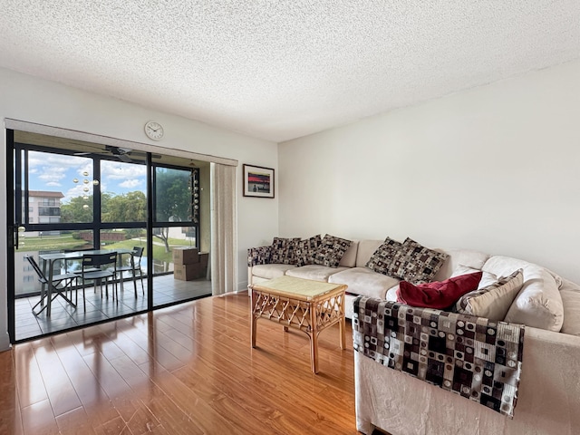 4960 E Sabal Palm Blvd Unit 206, Tamarac, FL 33319 - living area with wood finished floors and a textured ceiling