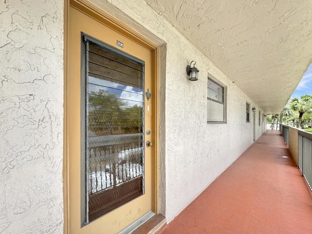 4960 E Sabal Palm Blvd Unit 206, Tamarac, FL 33319 - doorway to property with stucco siding and a balcony