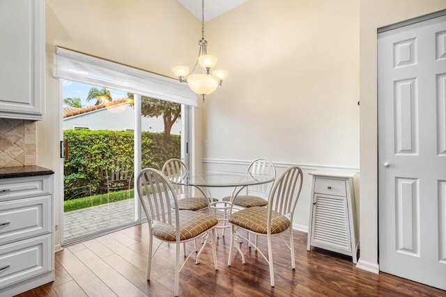7338 Chorale Rd, Boynton Beach, FL 33437 - dining room featuring dark wood-style floors and a chandelier