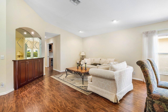 7338 Chorale Rd, Boynton Beach, FL 33437 - living area featuring dark wood-style flooring, arched walkways, vaulted ceiling, and baseboards