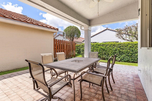 7338 Chorale Rd, Boynton Beach, FL 33437 - view of patio featuring outdoor dining space, a ceiling fan, and fence