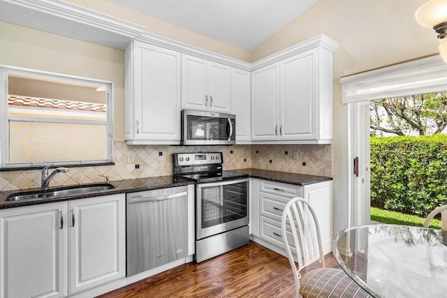 7338 Chorale Rd, Boynton Beach, FL 33437 - kitchen with stainless steel appliances, a sink, white cabinets, dark wood-style floors, and backsplash