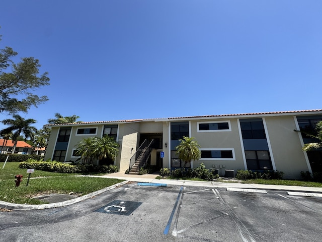 1453 Lake Crystal Dr Unit H, West Palm Beach, FL 33411 - view of building exterior featuring uncovered parking and stairway