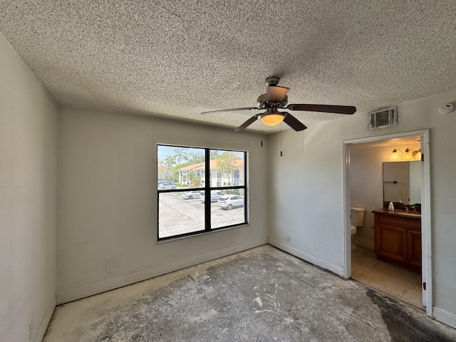 1453 Lake Crystal Dr Unit H, West Palm Beach, FL 33411 - unfurnished bedroom with a textured ceiling, baseboards, connected bathroom, and a ceiling fan