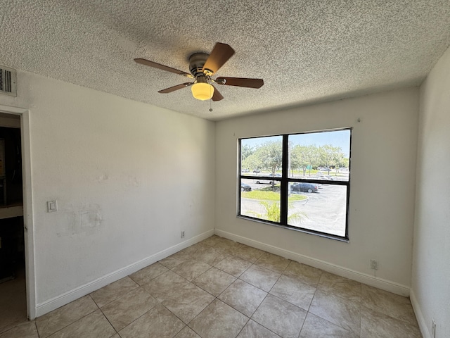 1453 Lake Crystal Dr Unit H, West Palm Beach, FL 33411 - empty room featuring a textured ceiling, ceiling fan, light tile patterned floors, and baseboards